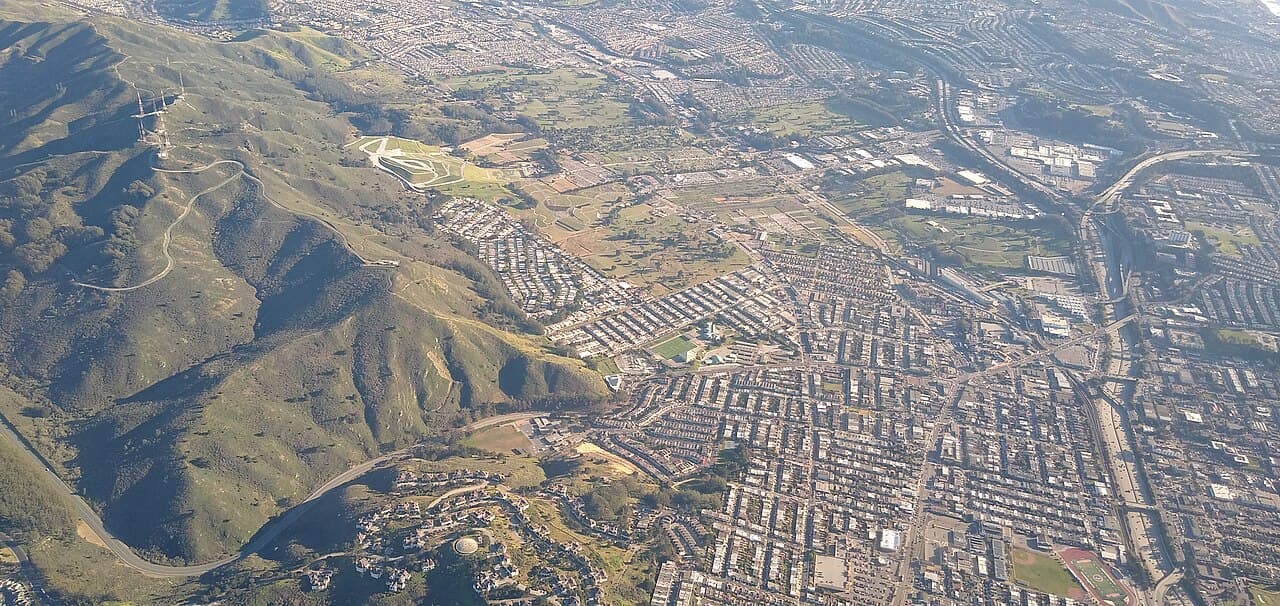 Aerial view of Daly City neighborhoods beside San Bruno Mountain.
