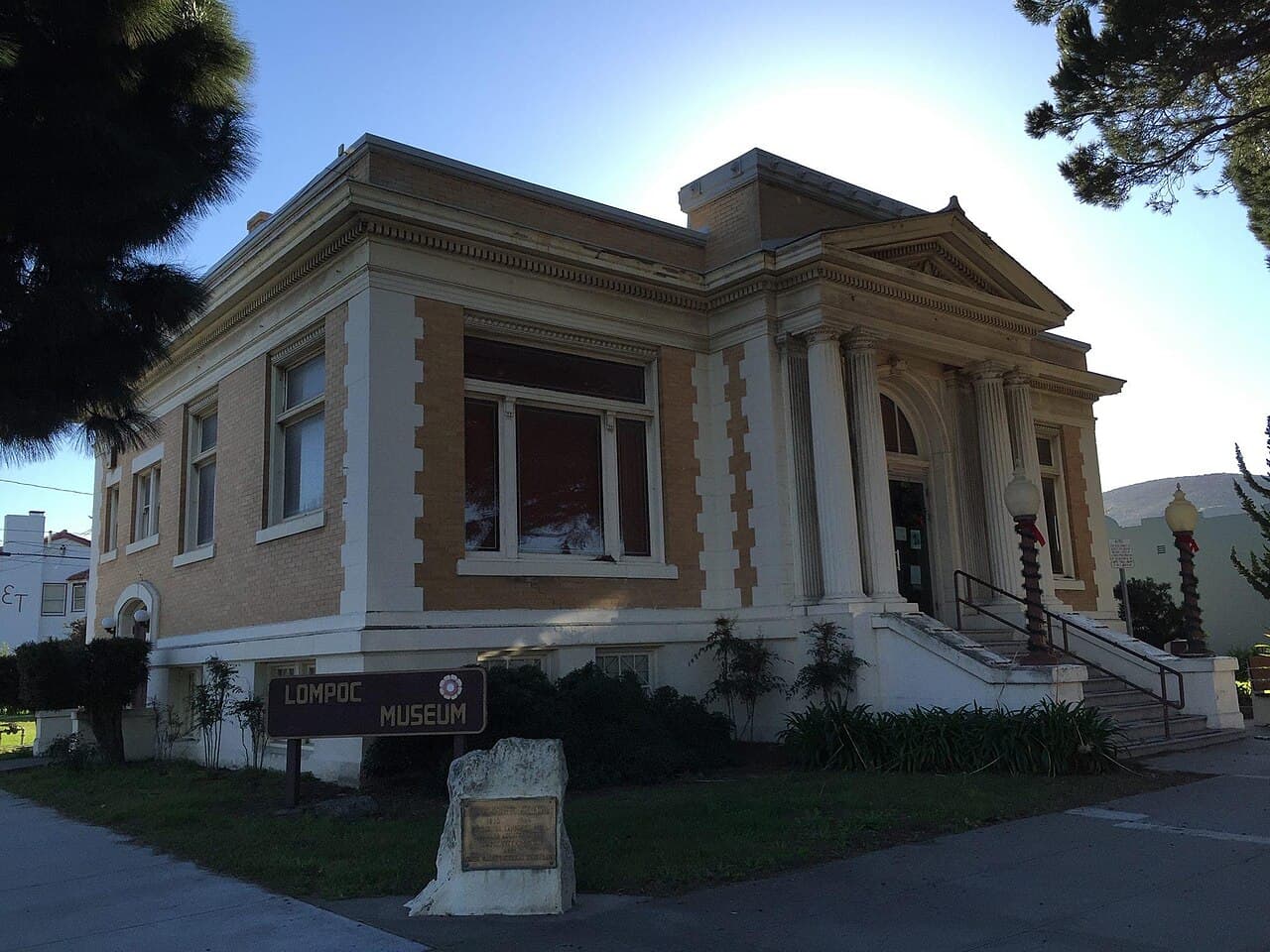 Lompoc Museum's classical facade and entrance steps framed by trees.