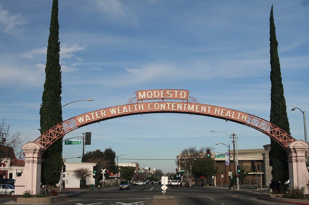 The Modesto Arch spanning the street with the city's Water Wealth Contentment Health motto.