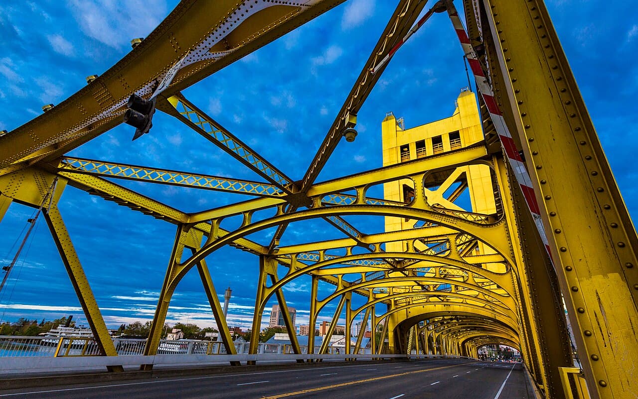 Sacramento's yellow Tower Bridge with the city skyline visible beyond its steel arches.